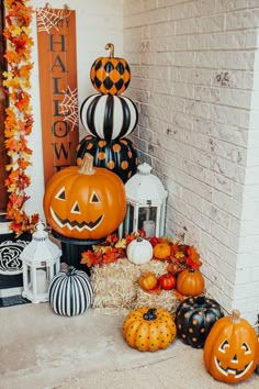 pumpkins and other decorations on the front porch