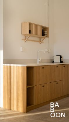 a kitchen with wooden cabinets and white walls