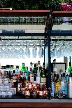 bottles and glasses are lined up behind a bar