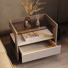 a coffee table with a book and vase on it