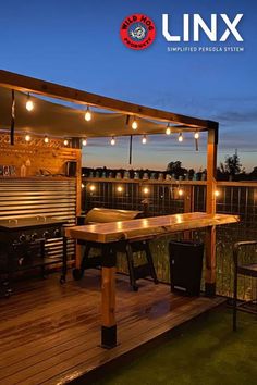 an outdoor bbq with lights on the roof