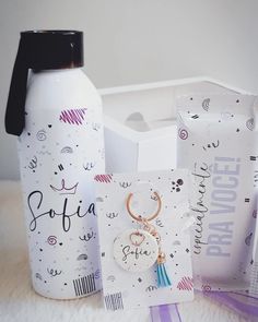 a bottle with a keychain, card and other items