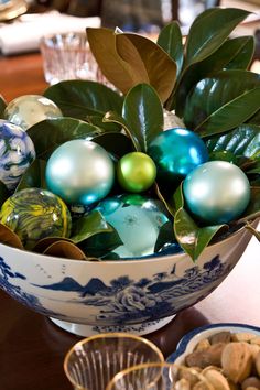 a bowl filled with ornaments sitting on top of a table