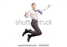 a young man jumping in the air with his arms wide open, wearing a suit and tie