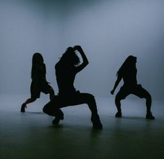 three silhouettes of people dancing in the dark