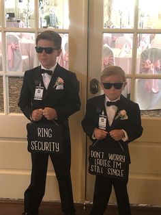 two young boys dressed in tuxedos holding signs reading ring security don't worry ladies i'm still single