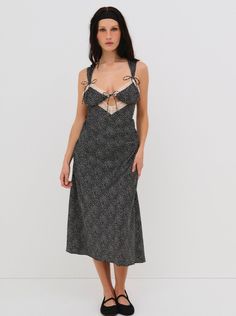 Inspired by 60s romance films, the Evangeline black midi dress imbues a sense of timelessness with its tiny dotted print and contrast lace trims along neckline. A cut-out at the center-front gives this slip dress a seductive edge. Black Midi Dress With Contrast Lace, Chic Black Slip Dress With Contrast Lace, Black Lace Trim Midi Slip Dress, Black Midi Slip Dress With Lace Trim, Polka Dot Dress With Lace Trim For Spring, Black Midi Dress With Lace Trim For Brunch, Sleeveless Polka Dot Dress With Lace Trim, Fitted Summer Midi Dress With Contrast Lace, Black Midi Dress With Lace Trim For Daywear