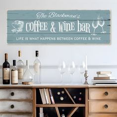 a wooden sign that says coffee and wine bar on the side of a table with glasses