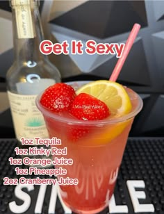 a drink with strawberries and lemon on the side