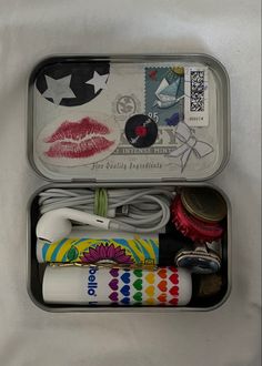 an open tin with various items in it