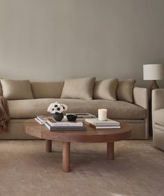 a living room with a couch, coffee table and two lamps on the side tables