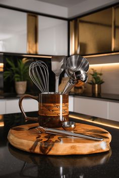 a kitchen counter top with utensils and spoons in a mug on it