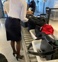 a woman standing in front of luggage at an airport