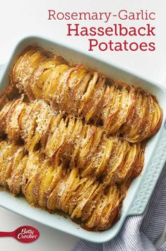 the cover of rosemary garlic hasselback potatoes in a casserole dish on a blue plate