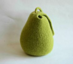 a small green bag sitting on top of a white surface