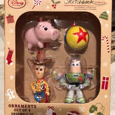 two toy figurines in a box with christmas decorations on the top and an ornament