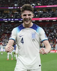 a male soccer player in a white and blue uniform