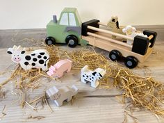 wooden farm animals and tractor on the floor