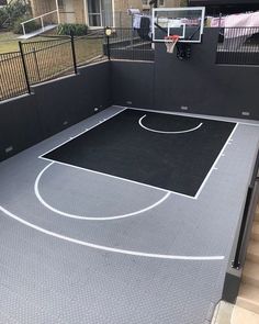 an indoor basketball court in the middle of a house with stairs leading up to it