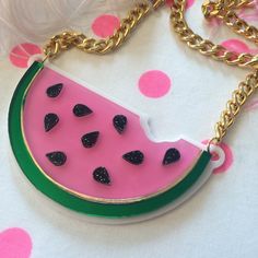 "This is a scrumptious necklace for all seasons! Bring the fun to any outfit with this big and bold watermelon necklace. This original design has been laser cut out of a mix of glitter, mirror, and opaque 1/8\" acrylic sheet and is backed with white, 1/16\" acrylic. The necklace hangs from a thick, gold chain and measures about 16\". We love these necklaces and think that they never get old. However, to prolong the life of yours, treat it with love! Be careful when storing it in a bag or pocket Fun Plastic Jewelry For Party, Trendy Pink Plastic Necklaces, Trendy Pink Plastic Necklace, Cute Handmade Plastic Necklace, Cute Party Necklaces For Summer, Cute Summer Party Necklaces, Fun Plastic Party Jewelry, Fun Resin Jewelry For Parties, Fun Resin Jewelry For Party