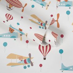 an airplane and hot air balloons wallpaper in various colors on a white background with red, orange, blue, and green balloons