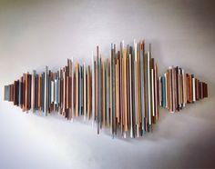 a wall sculpture made out of strips of wood