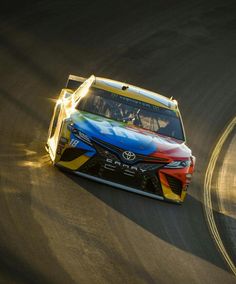 a colorful car driving on a race track