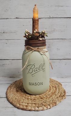 a mason jar with a candle in it