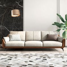 a living room with a couch, lamp and potted plant on the floor in front of it