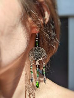 Handmade Tree of Life silver dangle earrings.🌿✨ The perfect boho hippie style accessory. Lightweight for comfortable wear. Silver laser cut Tree of Life pendants dangling on white gold plated hypoallergenic fish hook earring wire with green crystal beads and silver leaf charms. Handmade with love! ❤️ **I started my crystal suncatcher business in 2022 in memory of my soulmate fur-kitty, Peep, who absolutely adored the sunshine. He was the sunshine of MY life, so in his honor, I create beautiful pieces that capture the sun he loved so much. Thank you for supporting my business Bohemian Tree Of Life Jewelry For Meditation, Bohemian Tree Of Life Round Pendant Jewelry, Sterling Silver Tree Of Life Nature-inspired Jewelry, Gift For Plant Lover, Adjustable Tree Of Life Pendant Jewelry, Tree Of Life Jewelry Inspire Uplift ⭐, Handmade Tree, Tree Of Life Earrings, Tree Jewelry