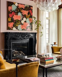 a living room filled with furniture and a fire place in front of a painting on the wall