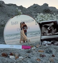 a couple kissing in front of a mirror on the beach