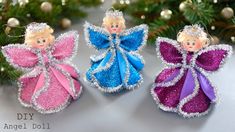 three christmas angel ornaments sitting on top of a table