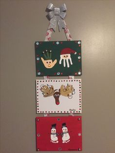 three christmas cards hanging on the wall with bows and snowman decorations attached to them