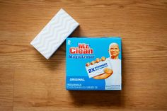 a box of mr clean magic eraser sitting on top of a wooden table next to a bar of soap