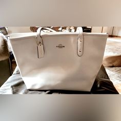 Authentic Cream/Chalk Colored, Crossgrain Leather Tote By Coach. Inside Zip, Cell Phone & Multifunction Pockets; Zip Closure, Handles W/ 9 1/2" Drop; 16" (L) X 10 1/2" (H) 5 1/2" (W) Tag Still Attached. Non-Smoking Home. Brand New Never Used Has No Marks Or Stains At All! Large White Luxury Bag, White Coach Shoulder Bag For On-the-go, Elegant Large Bag For Errands, Elegant Large Bags With Handles, Large Elegant Bag, Elegant Large White Bag, White Bags With Silver-tone Hardware For Shopping, White Bags With Silver-tone Hardware And Double Handle, Coach White Large Capacity Shoulder Bag