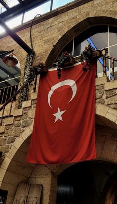 a large turkish flag hanging from the side of a building