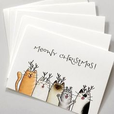 three christmas cards with cats on them and the words merry christmas written in black ink