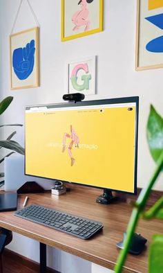 a computer monitor sitting on top of a wooden desk next to a keyboard and mouse