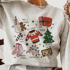 Step Into The Season Of Joy With Our 'Christmas Traditions Illustrated Sweatshirt'. Boasting Vibrant Hand-Drawn Illustrations That Capture The Essence Of The Holidays, From The Warmth Of 'Milk & Cookies' To The Fun Of 'Ugly Sweaters'. This Cozy Pullover Comes In A Variety Of Colors And Sizes, Available Exclusively On Our Website. Lovingly Crafted By Our Small Business, It's More Than A Sweatshirtit's The Spirit Of Christmas Wrapped In Comfort. Desert Bloom, The Spirit Of Christmas, Spirit Of Christmas, Woven Sweater, Winter Shirts, Star Sweater, Cozy Pullover, Warm Sweaters, Christmas Designs