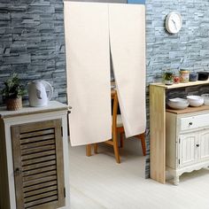 the kitchen is decorated in white and wood