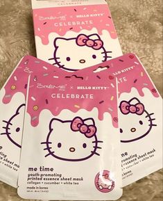 three hello kitty face masks with pink sprinkles on the front and side