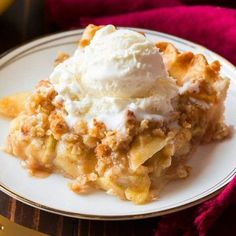 a piece of pie on a plate with ice cream and apples in the back ground