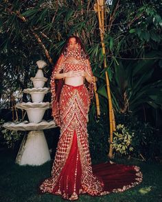 a woman in a red and gold wedding dress