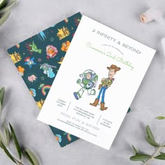 two cards with cartoon characters on them next to some leaves and flowers, one is for the