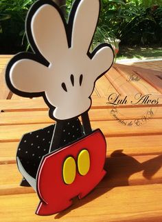 a mickey mouse cutout sitting on top of a wooden table