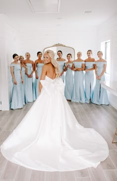 the bride is standing in front of her bridal party