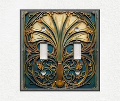 an intricately designed light switch cover with two lights on each side and one in the middle