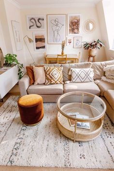 a living room filled with lots of furniture and decor on top of a white rug