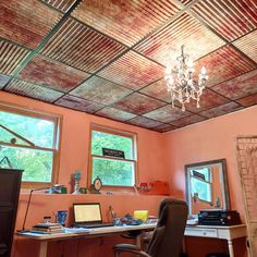 a room with a desk, chair and laptop on it